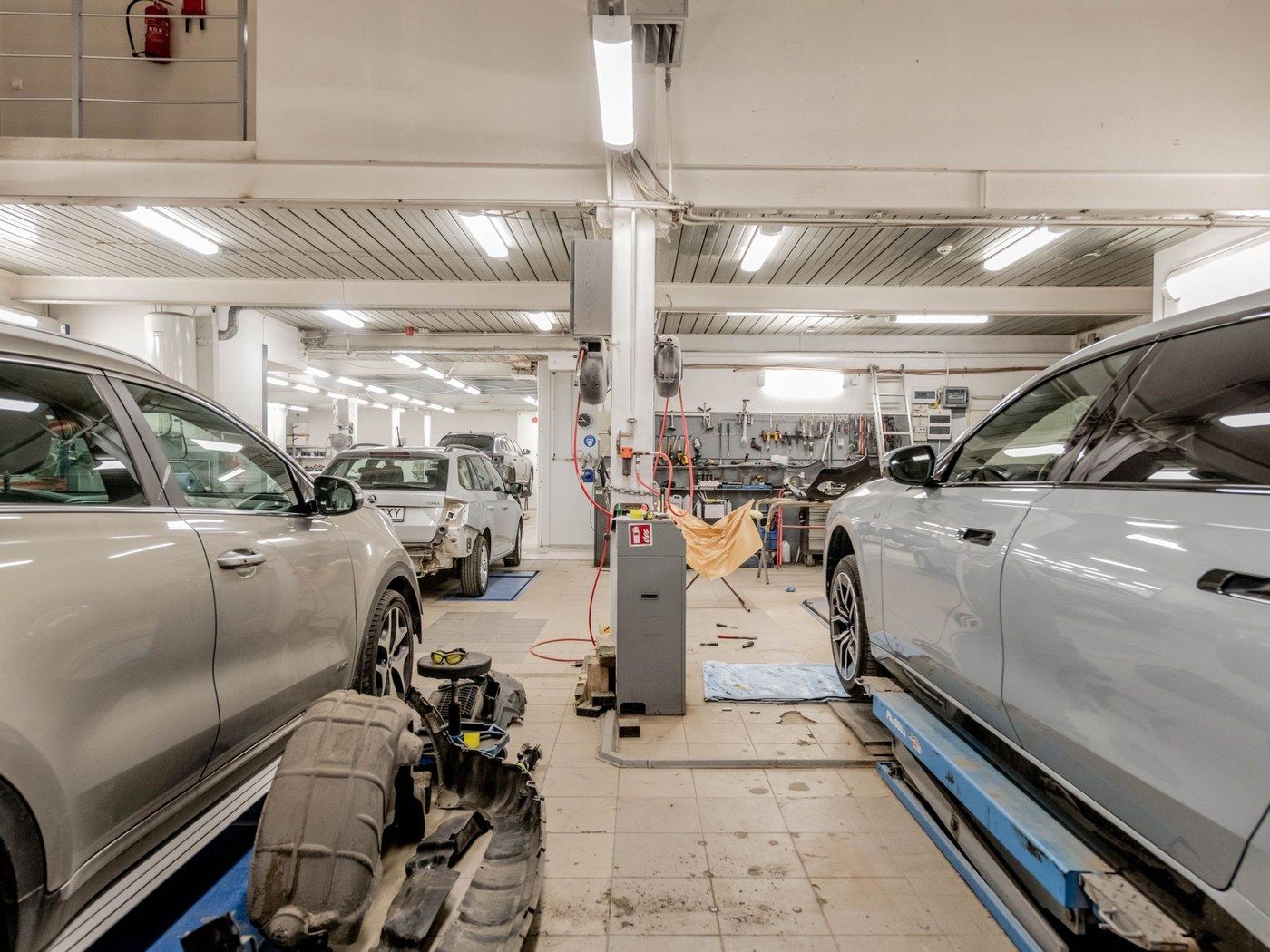 Cars in the service bays of a bright workshop