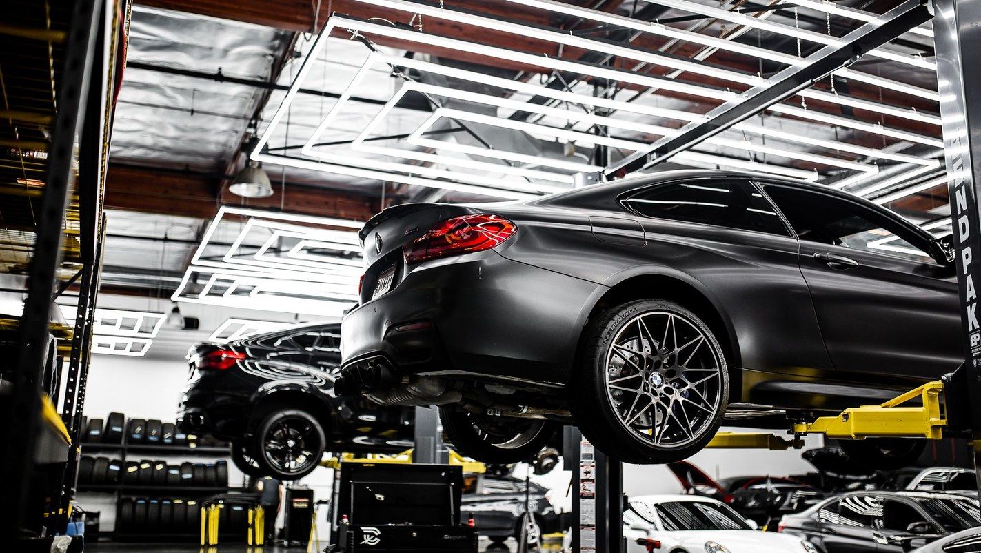 A car raised on a lift in a workshop