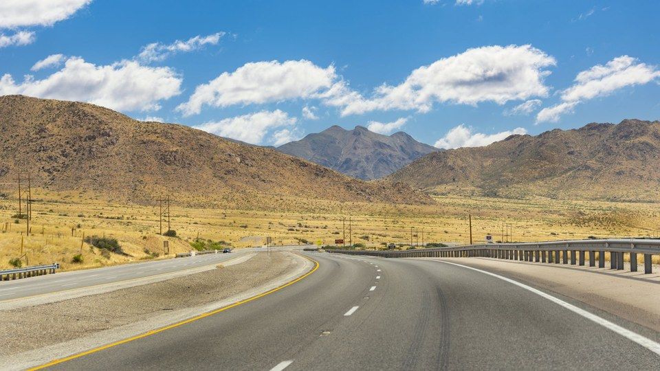 A highway running toward the Franklin Mountains in El Paso