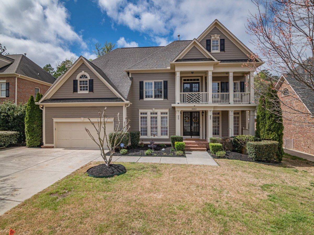 A two-story home with a gray shingle roof