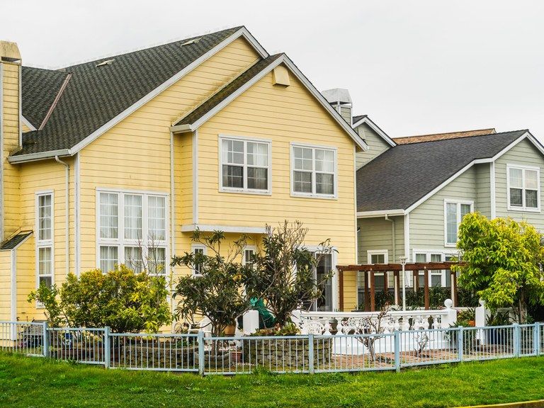 A two-story house with a front yard