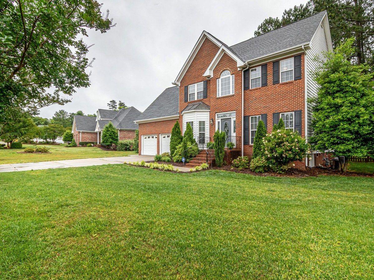 A finished brick home with a dark roof